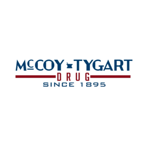 Logo for McCoy-Tygart Drug, a drugstore established in 1895, featuring blue typography and red accents on a white banner.