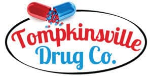 Logo for Tompkinsville Drug Co. featuring red 'Tompkinsville' and blue 'Drug Co.' text inside an oval with a red-blue pill graphic above it.