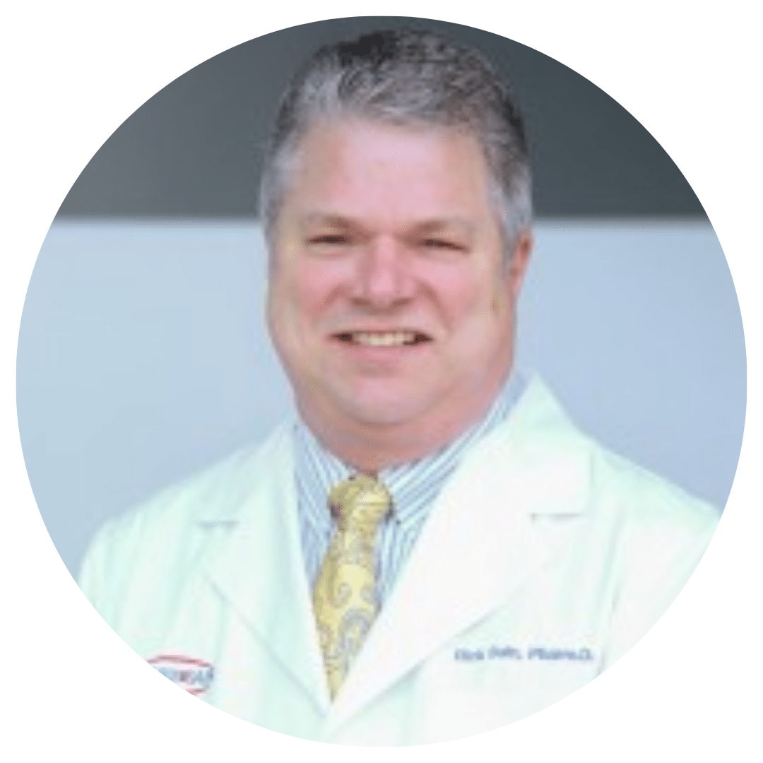 Smiling male doctor in a white coat and yellow patterned tie, circular crop image.
